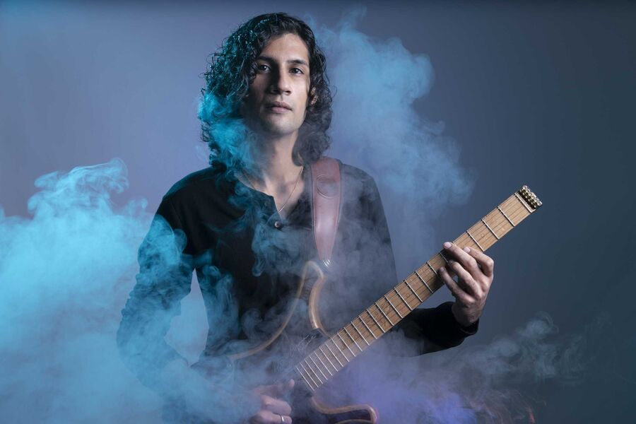 Guitarist surrounded by blue and purple smoke