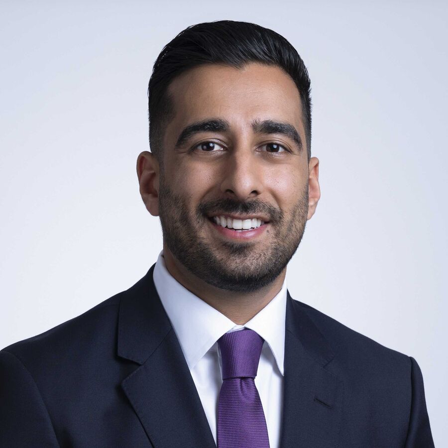 Professional headshot of a man in a suit