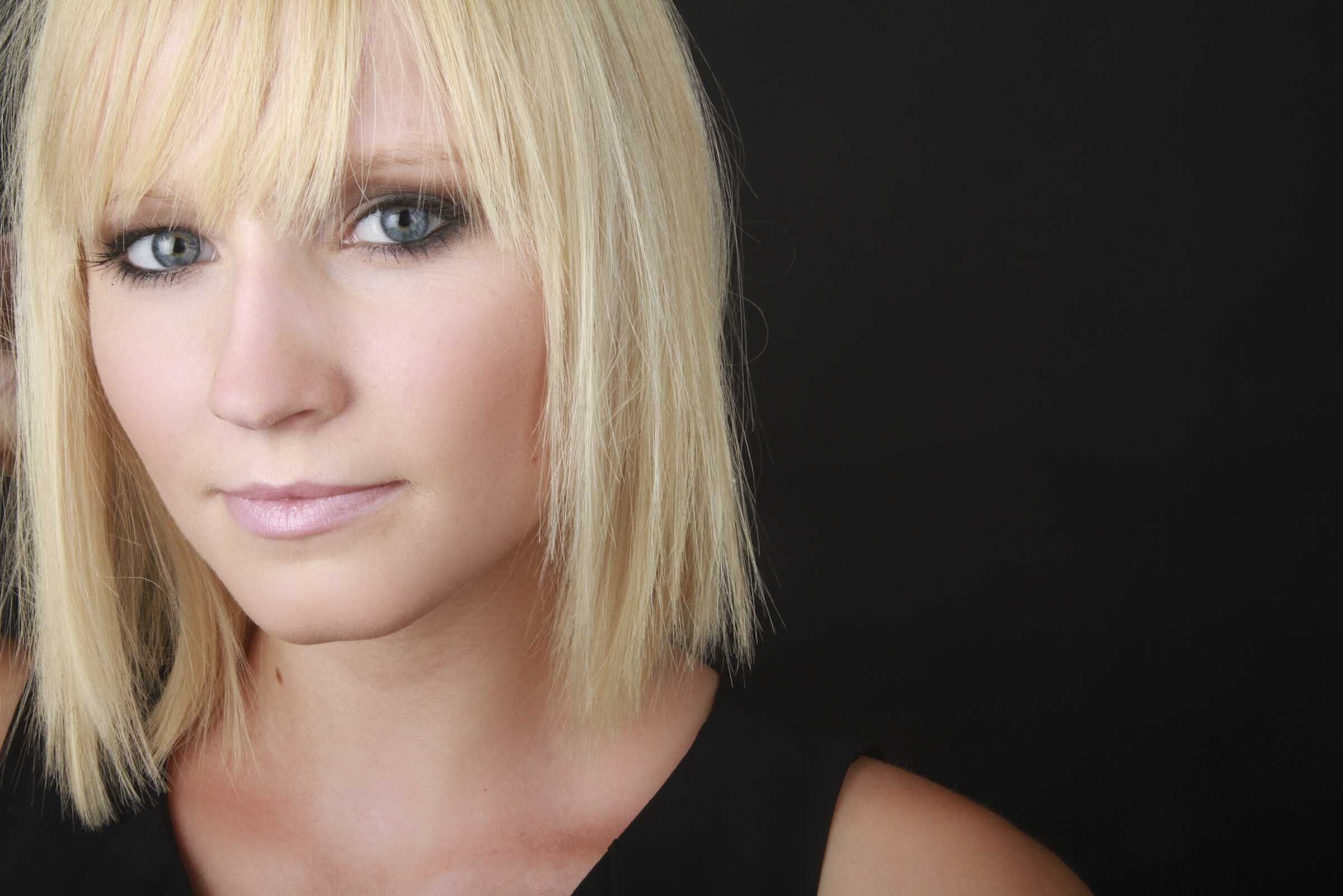 Close-up portrait of a woman with a platinum blonde bob